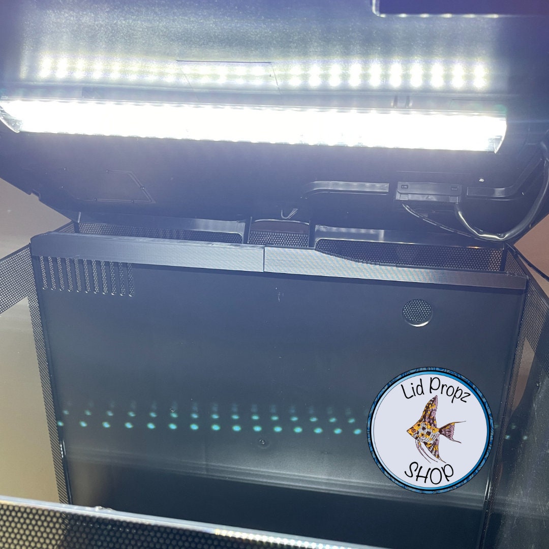 Nano fish swimming near a secured Fluval Flex chamber guard. Guard prevents access to the rear chamber without affecting water flow or filtration.