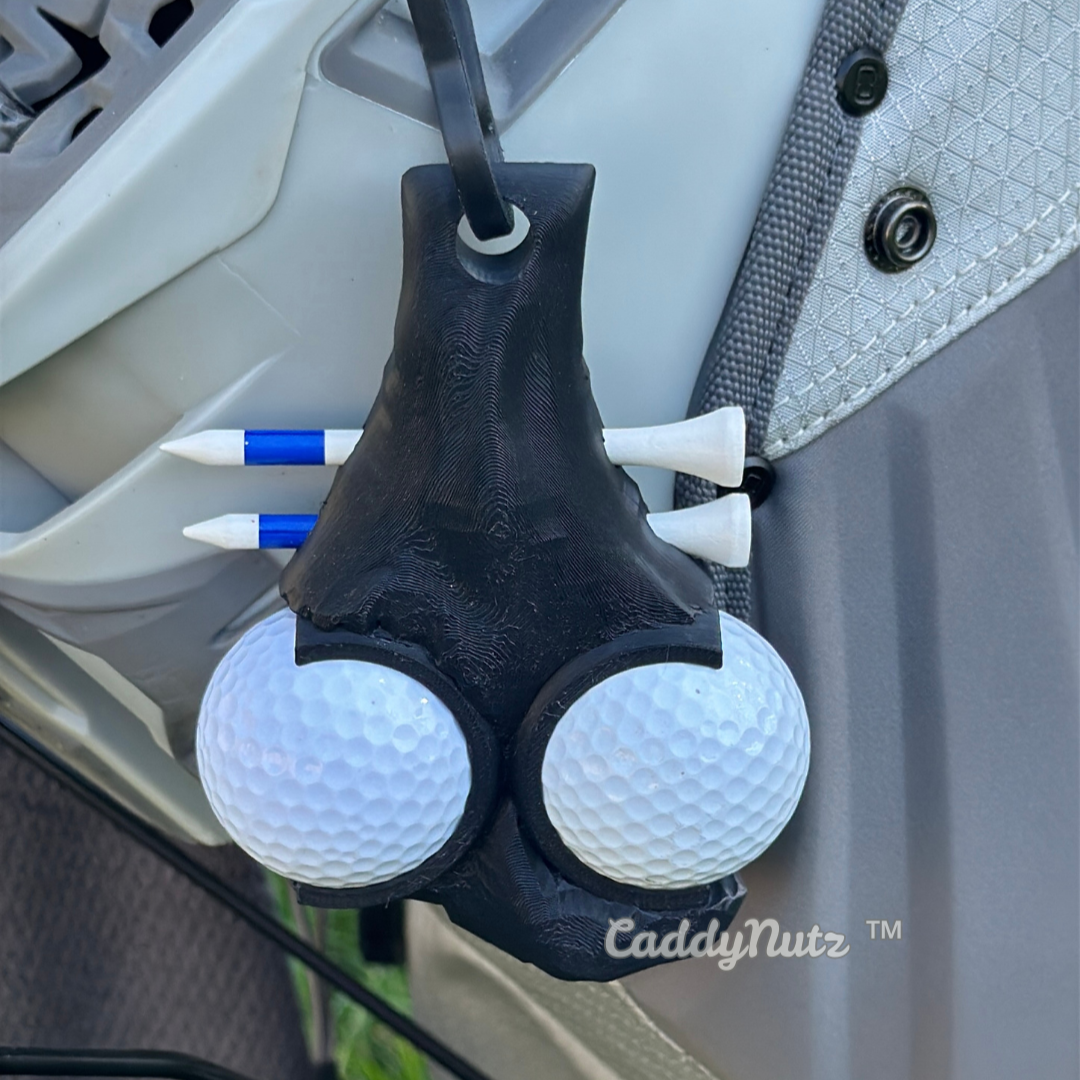 Golf ball holder with golf balls attached to a vehicle's door handle, featuring the brand 'CaddyNutz'.