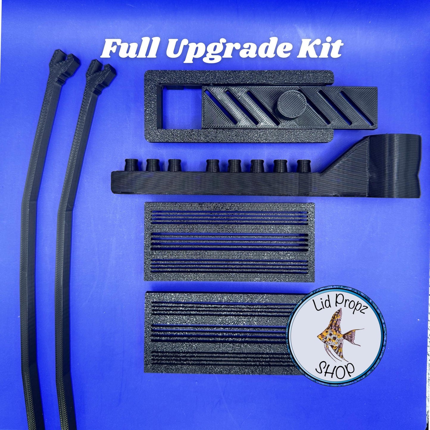 Fluval Flex upgrade kit components laid out: intake covers, feed hole cover, spray bar, and lid propz. Designed to improve safety and flow.